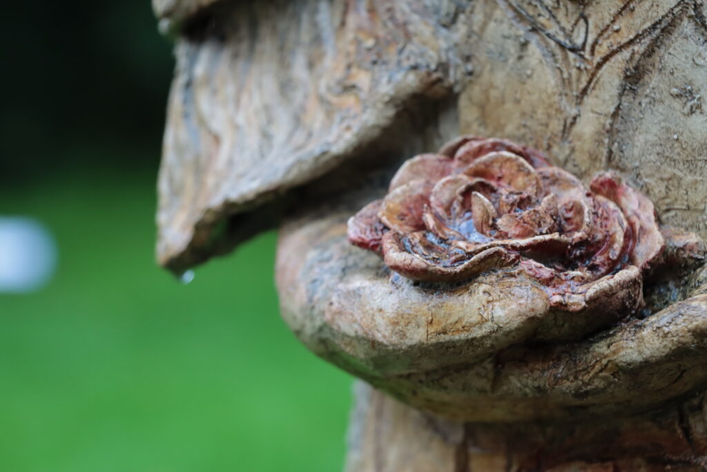 Skulptur Hände halten eine Blume